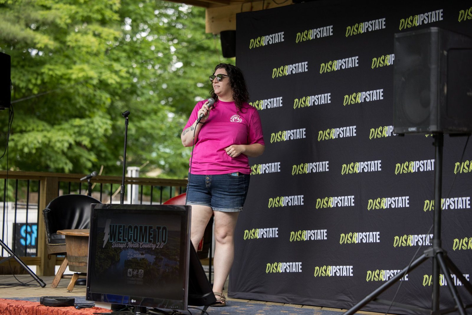 Lindsay Mastro hosting outdoors in front of a DisrUpstate backdrop